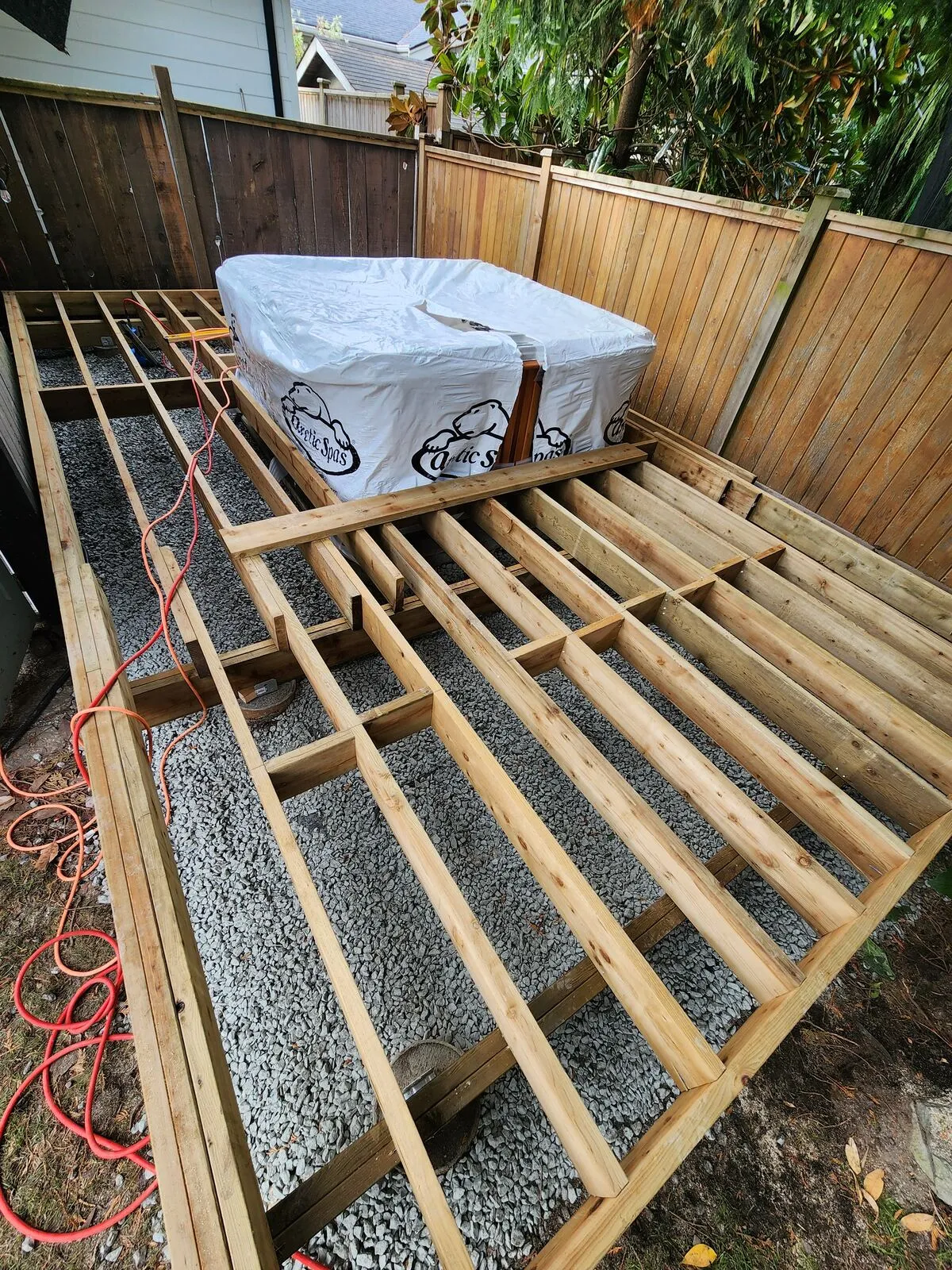 Gravel base and pressure-treated deck framing