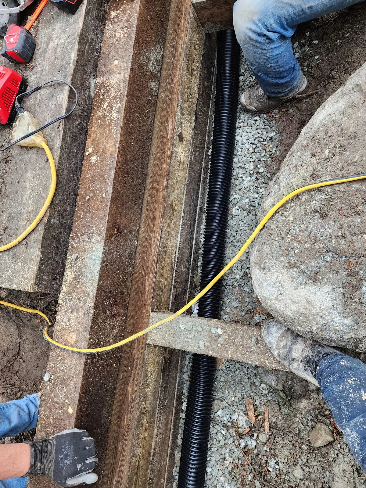 Drainage first: perimeter drain tile against the foundation