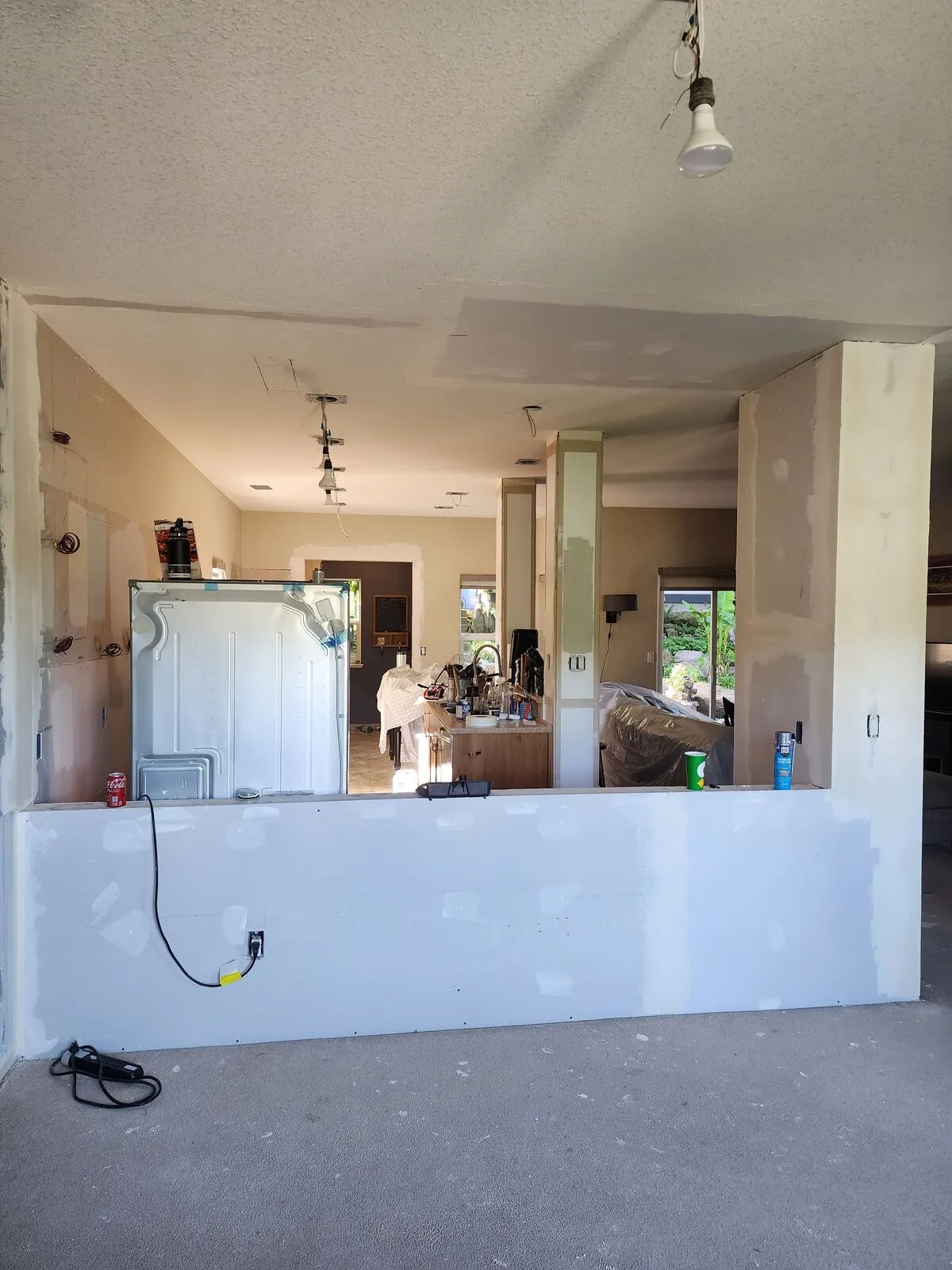 Opening the wall: load-bearing demo with services relocated inside