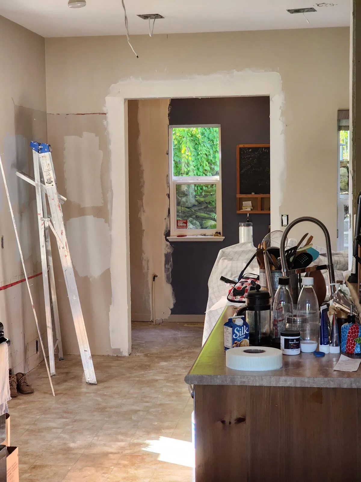 Opening the wall: load-bearing demo with services relocated inside