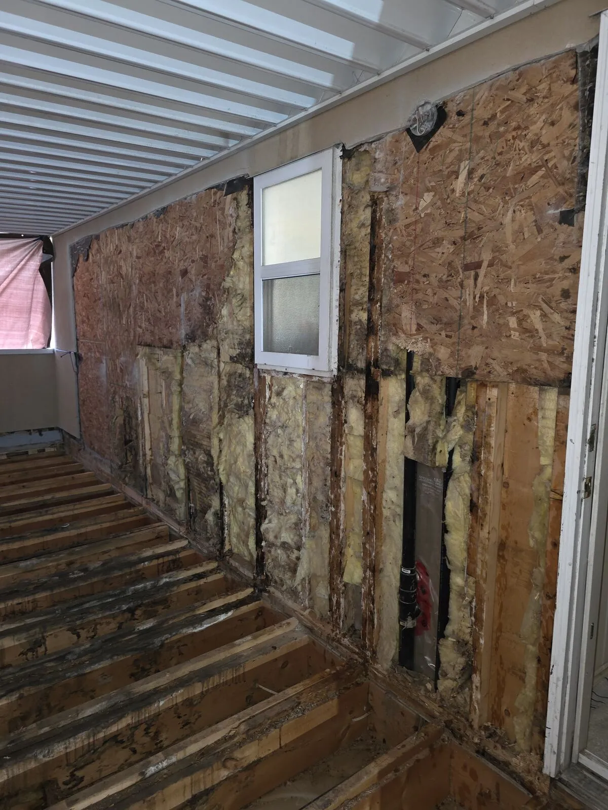 Exterior wall stripped during a building envelope repair by Valart Solutions