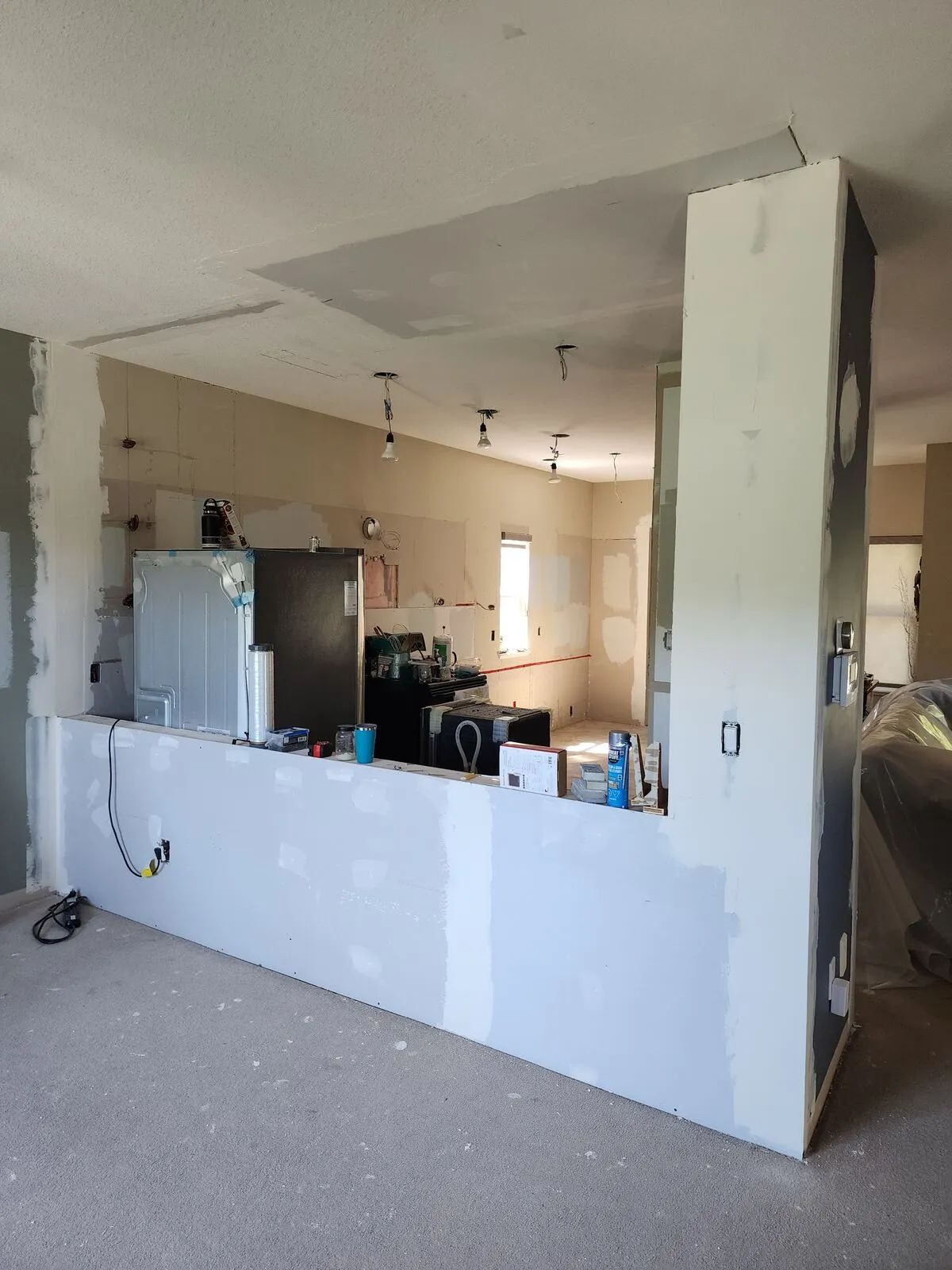 Opening the wall: load-bearing demo with services relocated inside