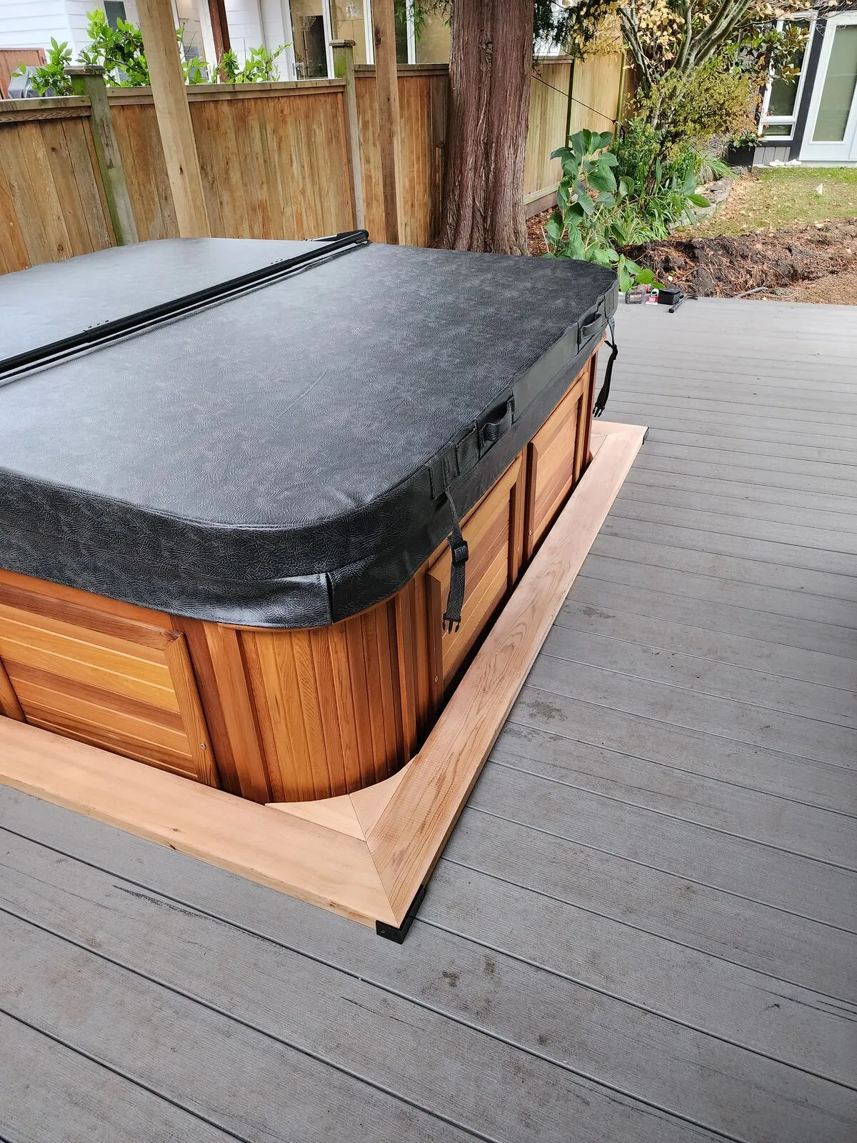 Composite deck and cedar trim skirt at the hot tub