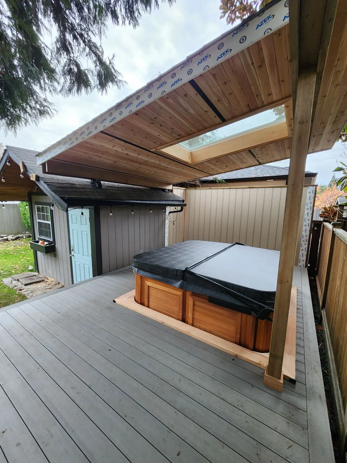 Composite deck and cedar trim skirt at the hot tub