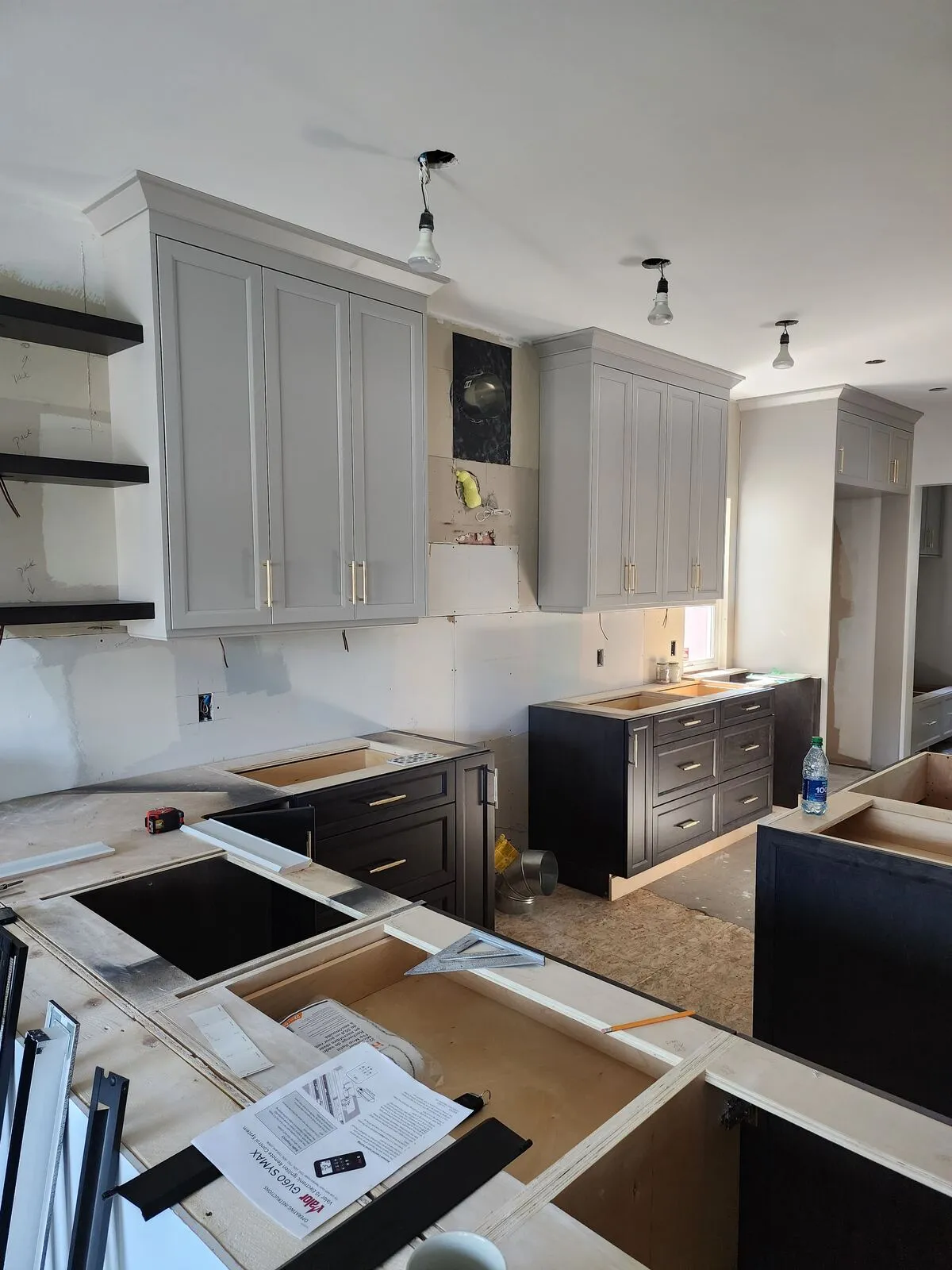 The new kitchen: warm-grey Shaker, quartz peninsula, mosaic backsplash