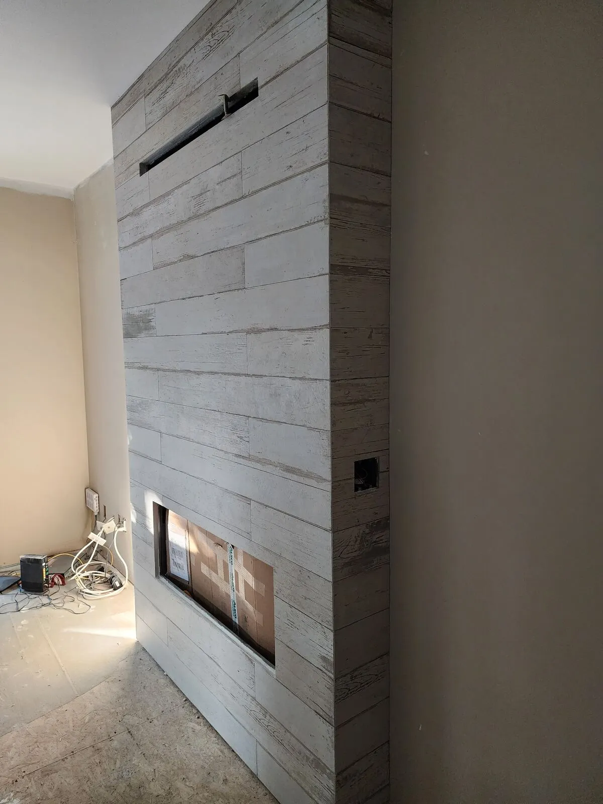 Rebuilding the fireplace: linear gas, whitewashed plank tile, 45° mitred corners