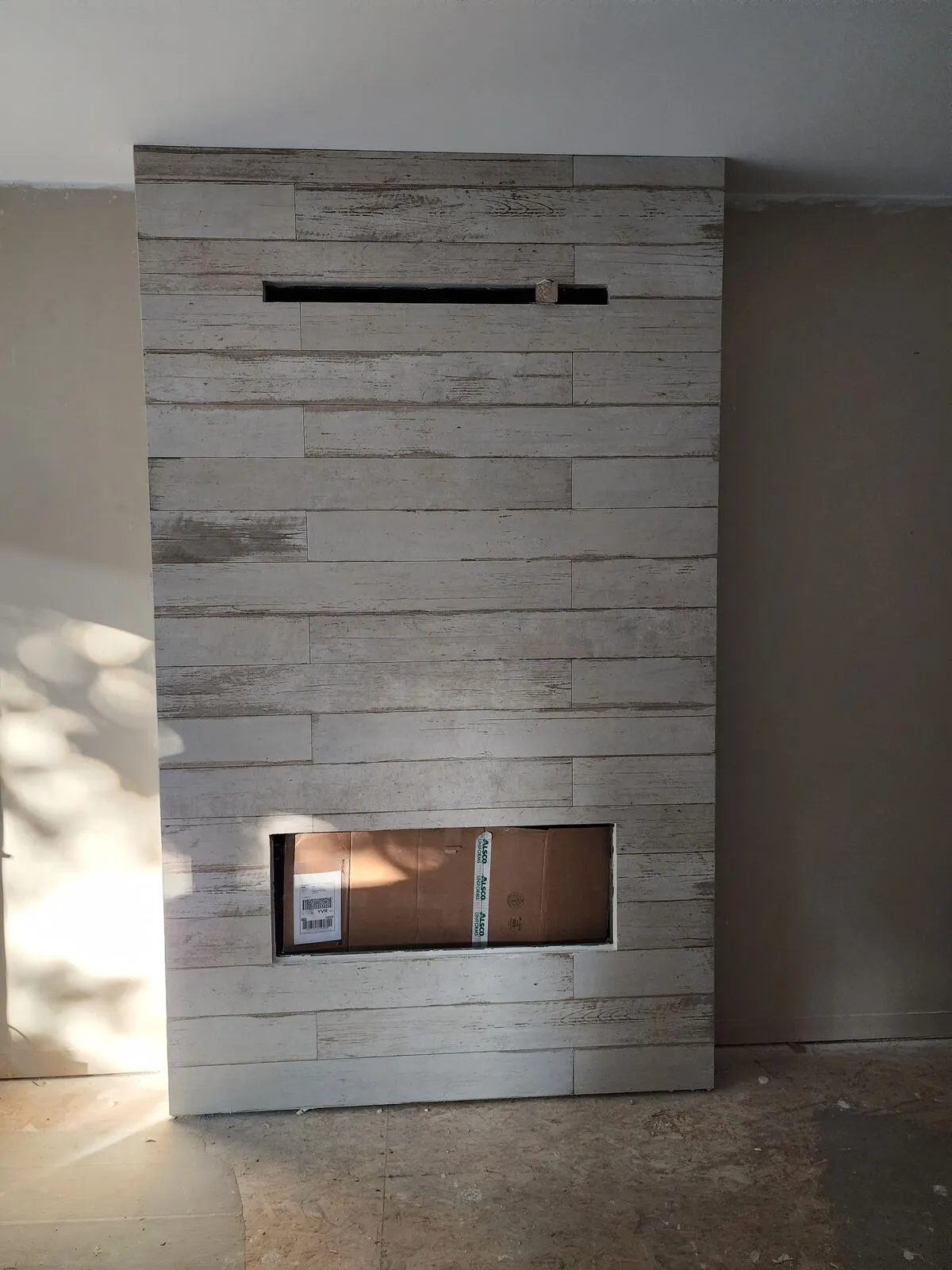Rebuilding the fireplace: linear gas, whitewashed plank tile, 45° mitred corners