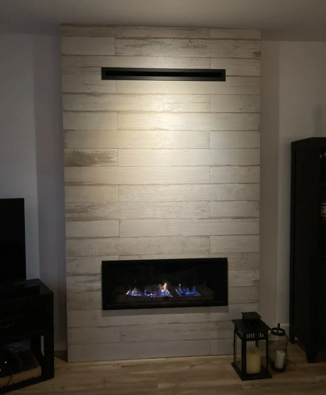 Rebuilding the fireplace: linear gas, whitewashed plank tile, 45° mitred corners