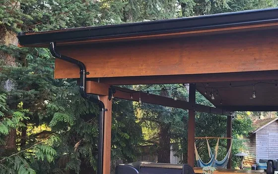 Cedar post-and-beam patio cover with hanging lights in Langley, BC